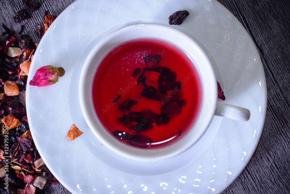 Cup of tea mix of leaves, fruits and dried fruits on rustic back Cup of tea mix of leaves, fruits and dried fruits on rustic back