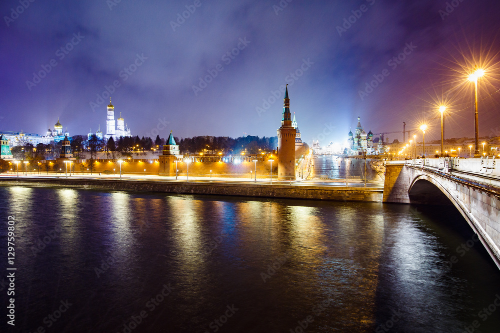 Night cityscape view of Moscow Kremlin, Basil's Descent and Red Square, embankment, street light at evening winter snowfall from Bolshoy Moskvoretsky Bridge in Moscow, Russia. Long exposure.