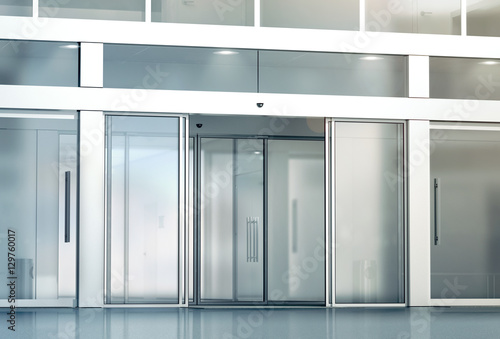 Blank sliding glass doors entrance mockup, 3d rendering. Commercial automatic slide entry mock up. Office building exterior template. Closed transparent business centre facade, front view. photo