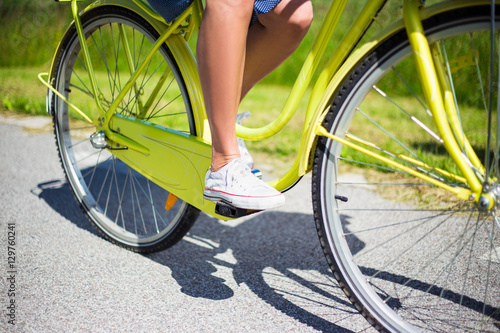 close up of woman riding vintage bicycle