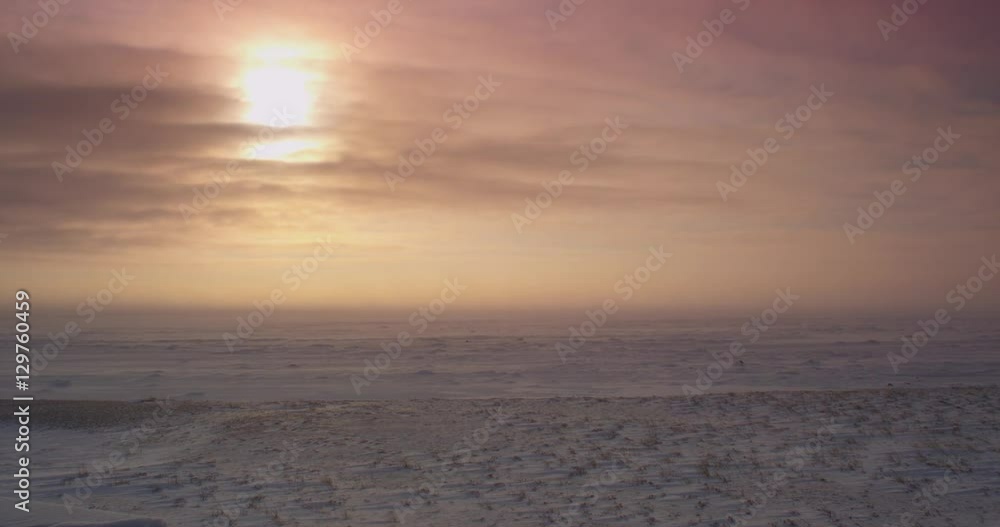 Waves of blizzard snow and clouds pass over tundra in storm Waves of blizzard snow and clouds pass over tundra in storm