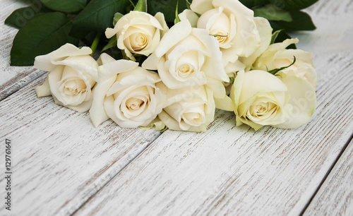 White roses on a wooden table
