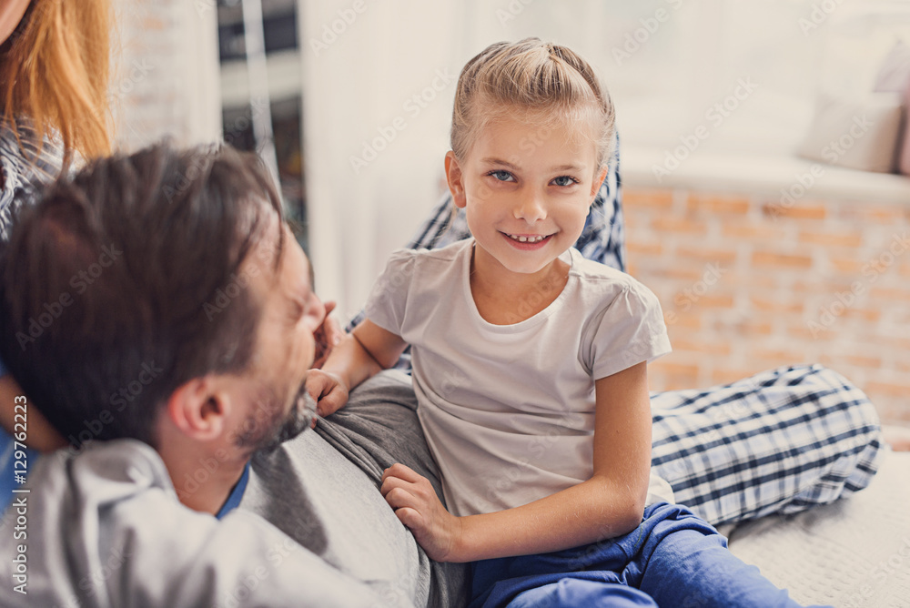 Happy family lying down on bed at home Happy family lying down on bed at home