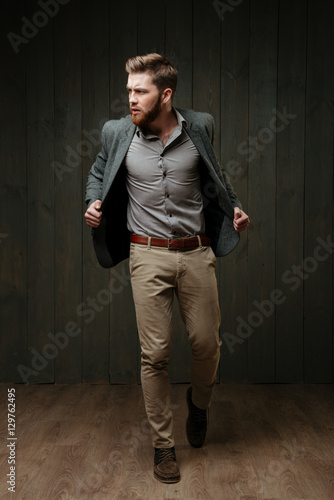 Handsome stylish man in jacket standing and posing