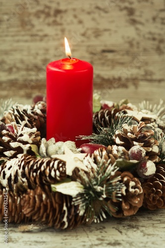 Burning candle in a Christmas wreath