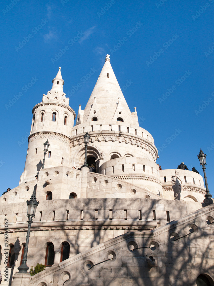 Typical light stone rounded fairy tale towers of Fisherman's Bastion, aka Halaszbastya, on a terrace in neo-Gothic and neo-Romanesque architectural style. Lookout turrets are situated on a Buda bank