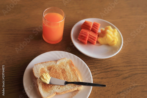 Set of healthy breakfast, plate of toast with butter and fresh f