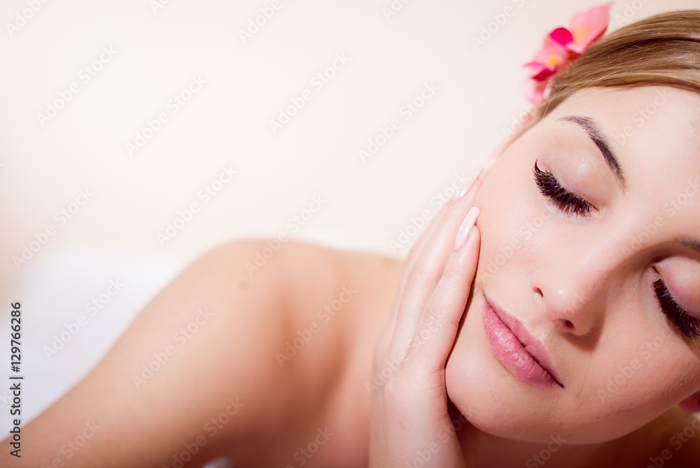 Naklejka premium Portrait pretty woman during spa massage procedures in salon