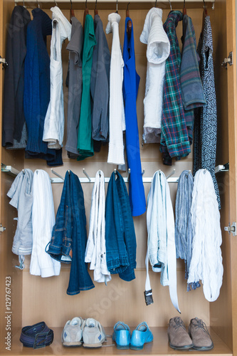 Wardrobe with clothing and shoes.