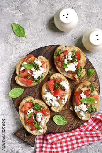 Italian bruschetta with tomatoes,feta and basil pesto .Top view. photo