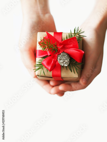 Christmas gift in the children's hands on the white background, isolate. Congratulations to the new year, gift presentation.