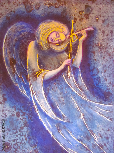 The girl an angel plays a soul melody on a violin. The image of an angel on is violet a blue background