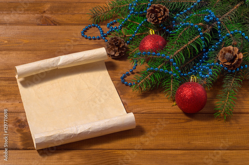 New Year's toys and spruce branches on a wooden background