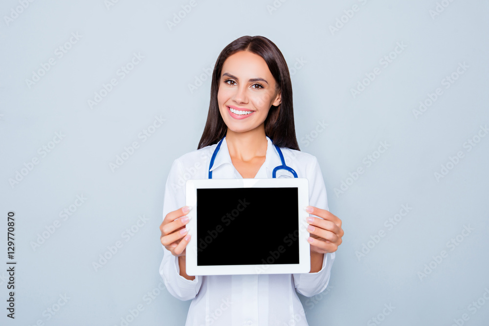 Pretty smiling doctor showing black screen of tablet Pretty smiling doctor showing black screen of tablet