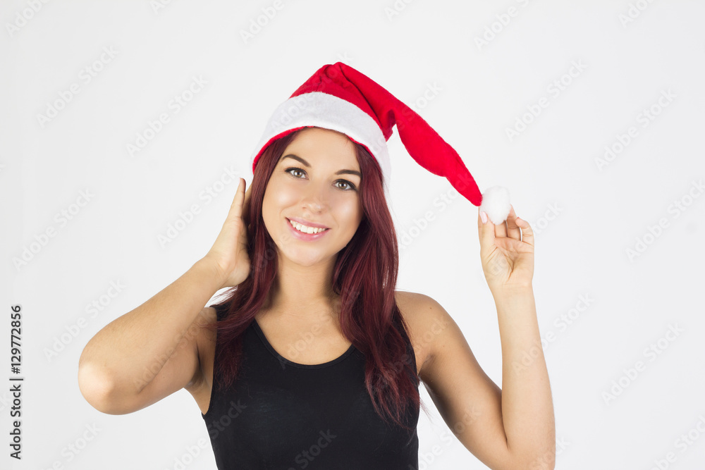 Beauty happy woman with santa hat touching her head and hat. Christmas mood. Beauty happy woman with santa hat touching her head and hat. Christmas mood.