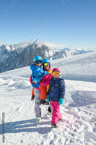Happy family enjoying winter vacations in mountains . Ski, Sun,Snow and Fun.