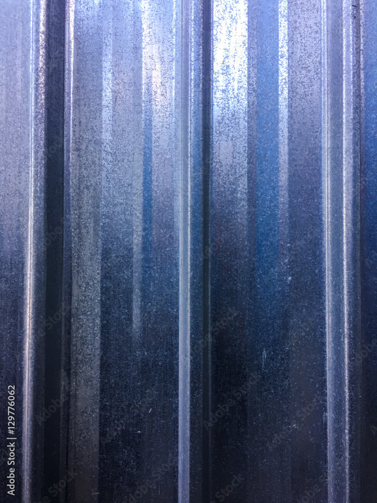 Galvanized, corrugated sheet metal. Corrugated galvanized fence background. Iron wall, dirty
