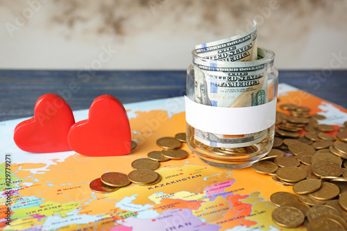 Glass jar with money on wor...