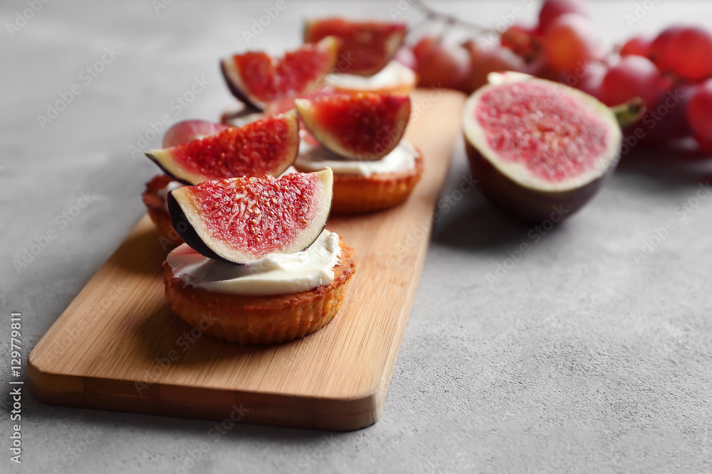 Delicious fig tarts on wooden cutting board Delicious fig tarts on wooden cutting board