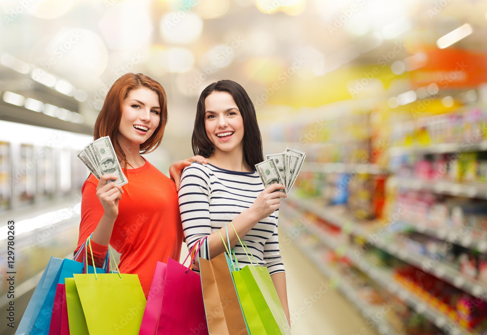 smiling teenage girls with shopping bags and money smiling teenage girls with shopping bags and money