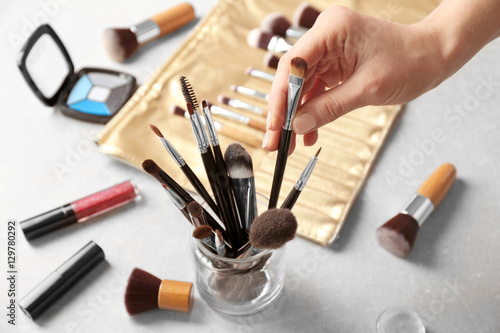 Female makeup artist hand with professional brush at work