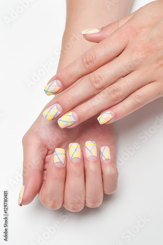 Matte nail polish pink, beige, striped, blue, and yellow on long square nails