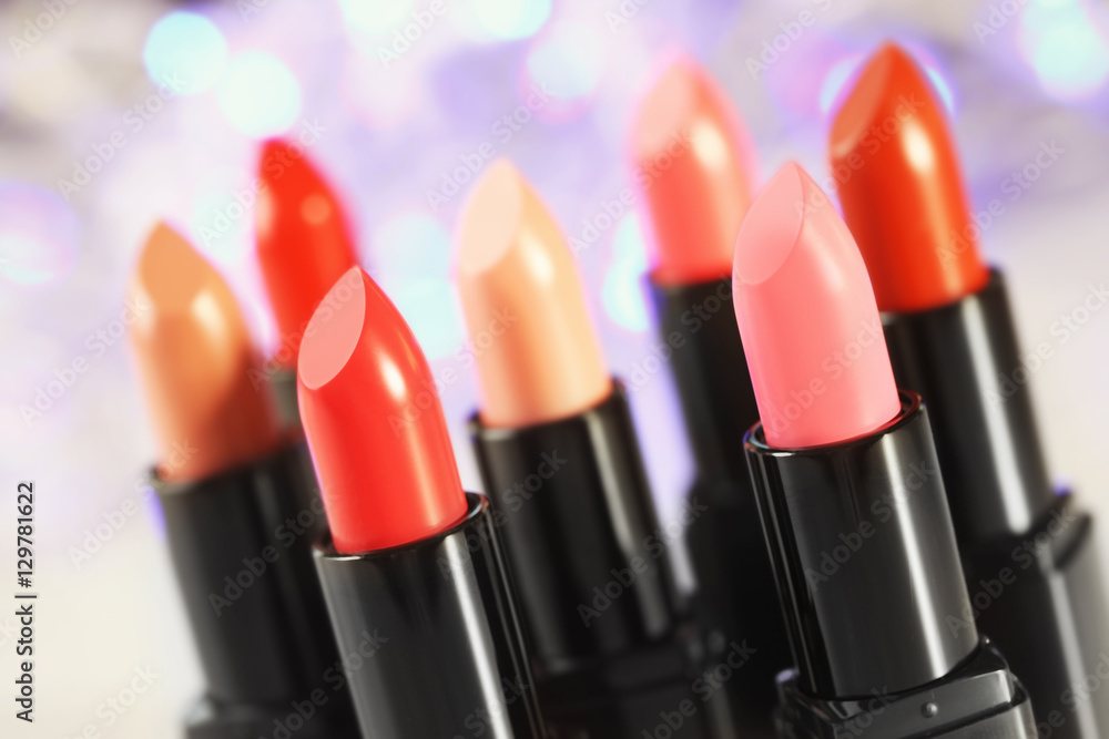 Obraz premium Collection of lipsticks on blurred lights background