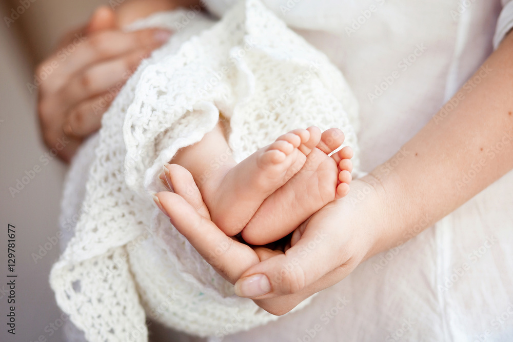 Baby feet in mother hands. Tiny Newborn Baby's feet on female Sh Baby feet in mother hands. Tiny Newborn Baby's feet on female Sh