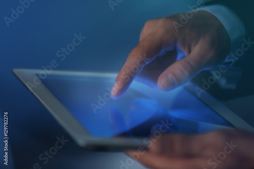Businessman touching screen of modern tablet, closeup