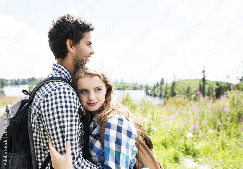 Young couple embracing on a hiking tour Young couple embracing on a hiking tour
