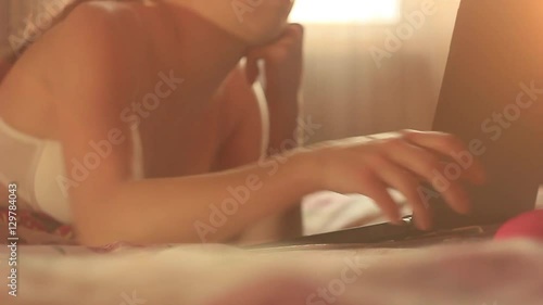 Wallpaper Mural girl lying on bed with laptop Torontodigital.ca