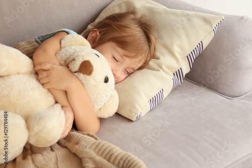 Small sick girl with Teddy ...