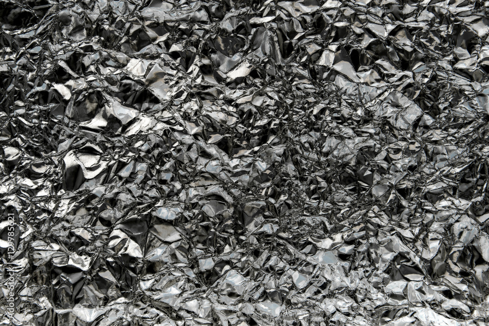 Crumpled wrinkled silver foil texture.Dark silver foil texture b