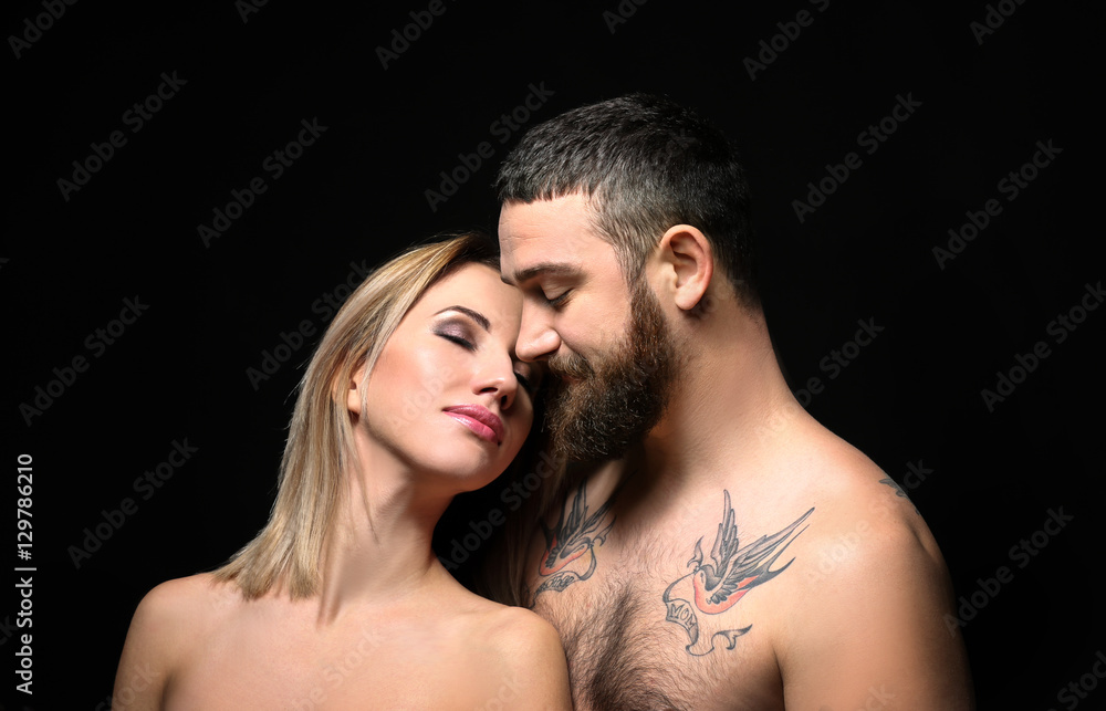 Portrait of romantic tattooed couple on black background Portrait of romantic tattooed couple on black background