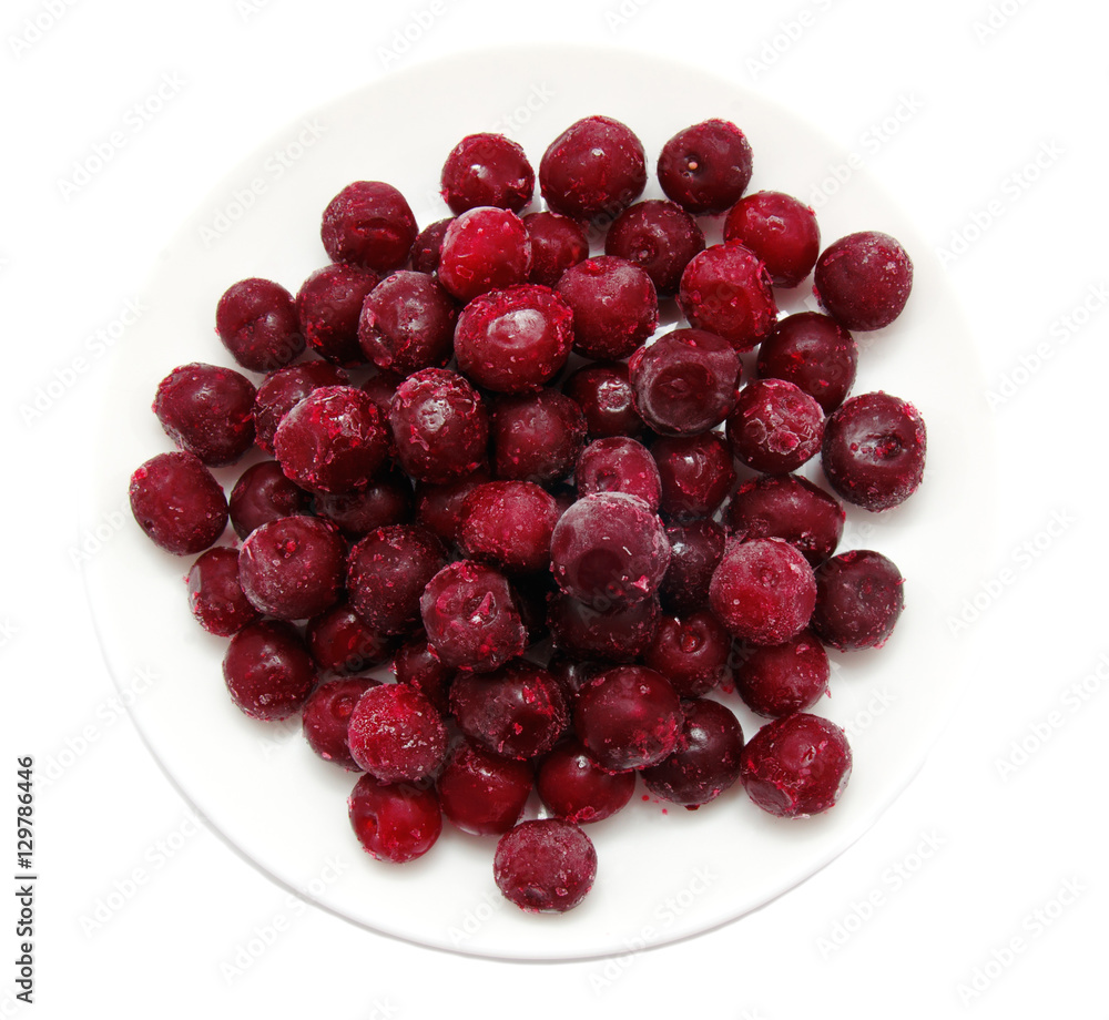 Frozen sweet cherries on white plate Frozen sweet cherries on white plate