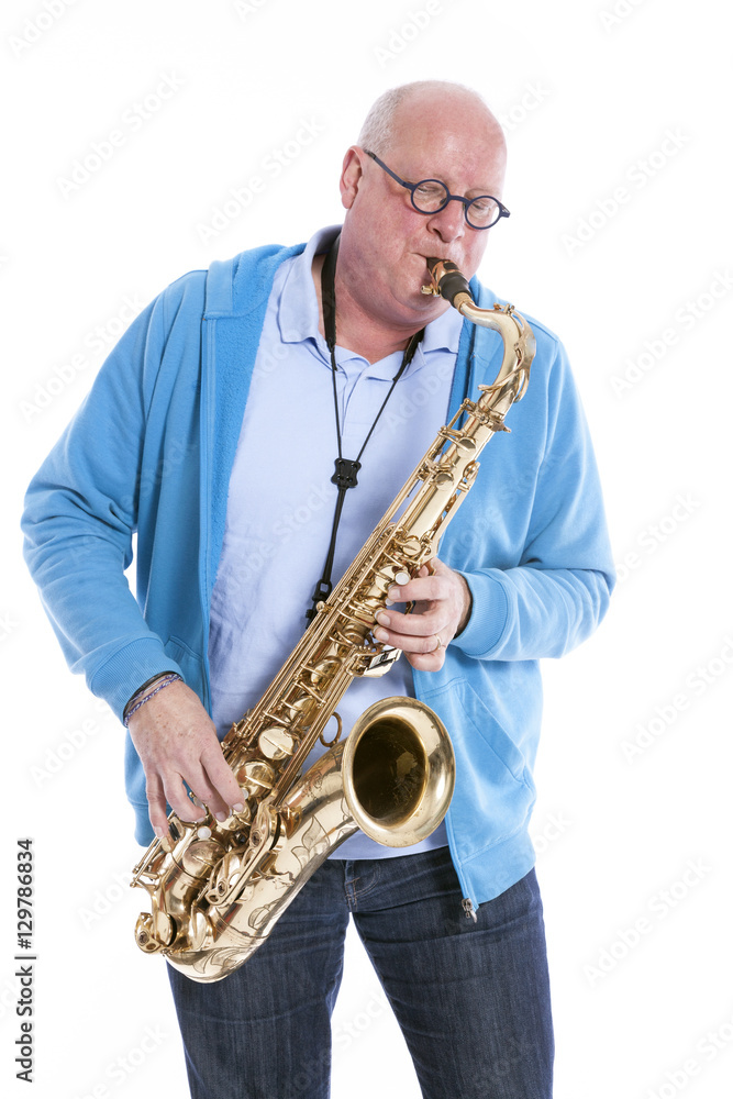 Naklejka premium middle aged man plays the tenor saxophone against white studio b