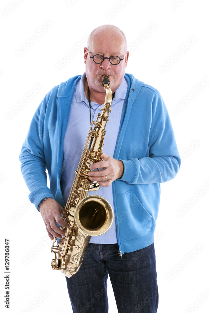 Fototapeta premium middle aged man plays the tenor saxophone against white studio b