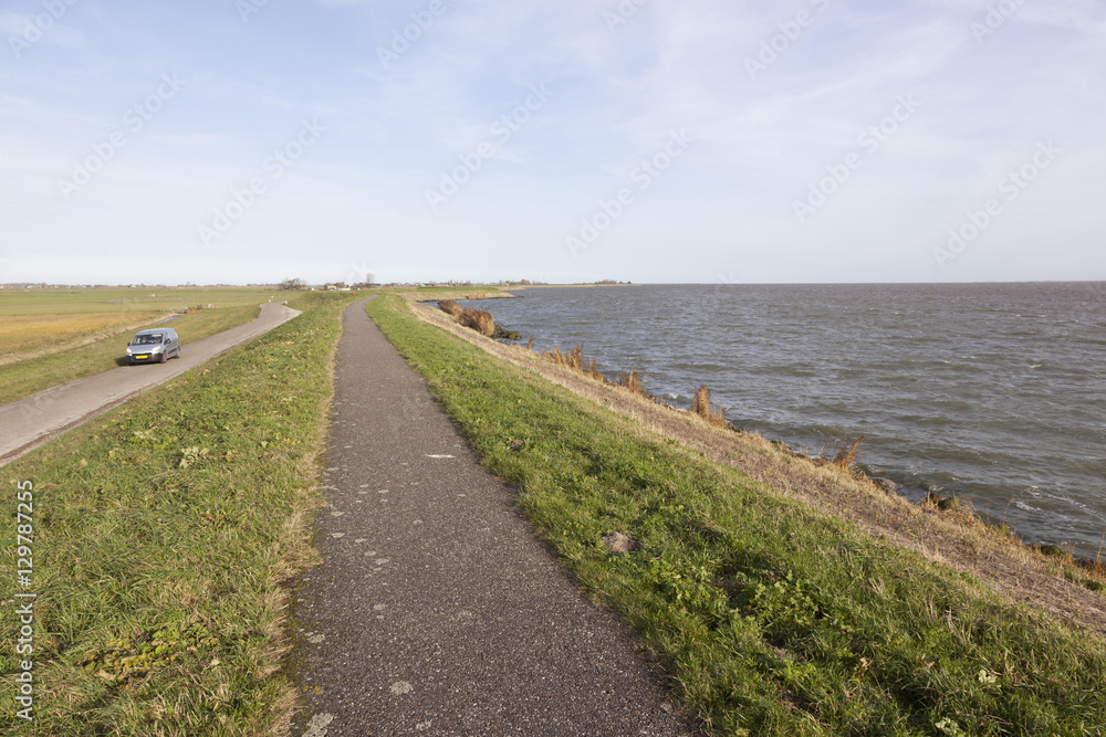 dike between meadow area and ijsselmeer in the netherlands dike between meadow area and ijsselmeer in the netherlands