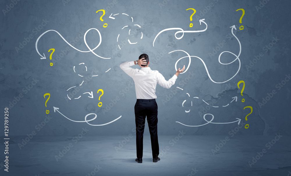 Unsure businessman with question marks Unsure businessman with question marks