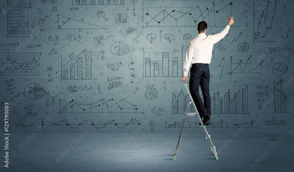 Man on ladder drawing charts Man on ladder drawing charts