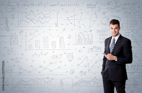 Salesman standing with drawn graph charts