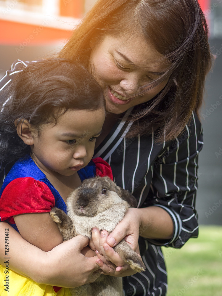 Asia woman and kid girl holding a rabbit. Asia woman and kid girl holding a rabbit.