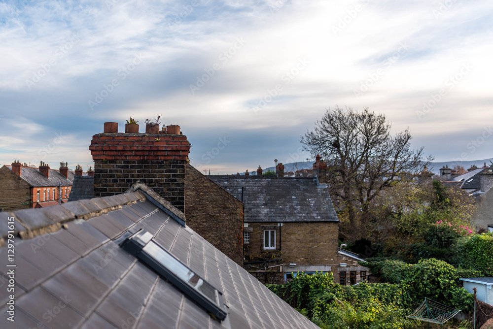 Roof tops blue sky and chimney tops