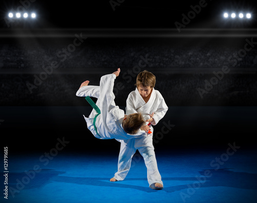 Boys martial arts fighters in sports hall