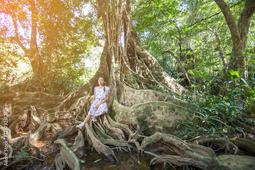 Wallpaper Mural asian girl on the base of trees in the forest. Torontodigital.ca