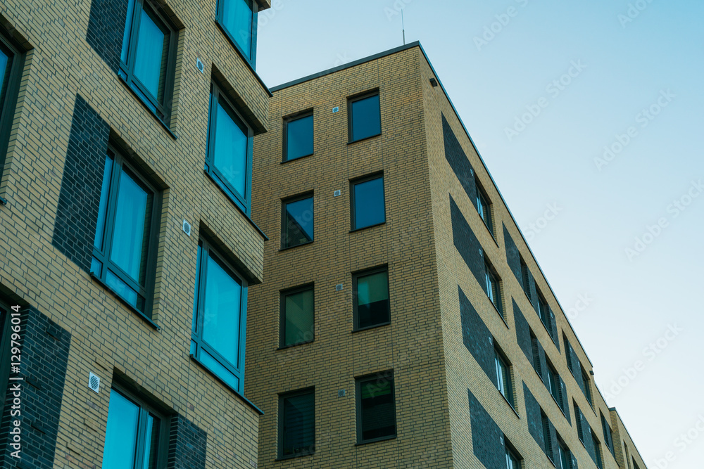 big and modern apartment buildings with blue windows