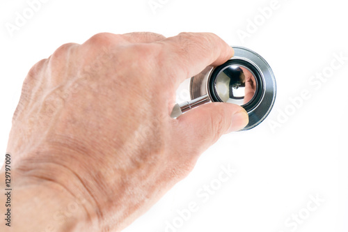 Stethoscope / View of stethoscope and hand on white background.