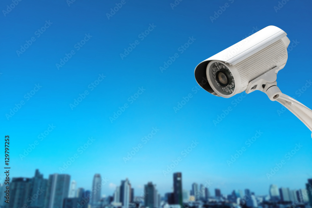 CCTV Camera security operating with buildings blur background CCTV Camera security operating with buildings blur background