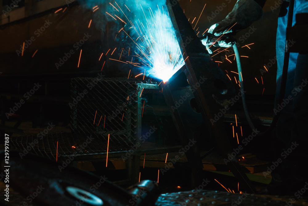 Welder of Metal Welding with sparks and smoke in manufacture Welder of Metal Welding with sparks and smoke in manufacture