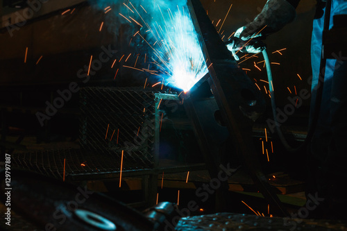 Welder of Metal Welding with sparks and smoke in manufacture 
